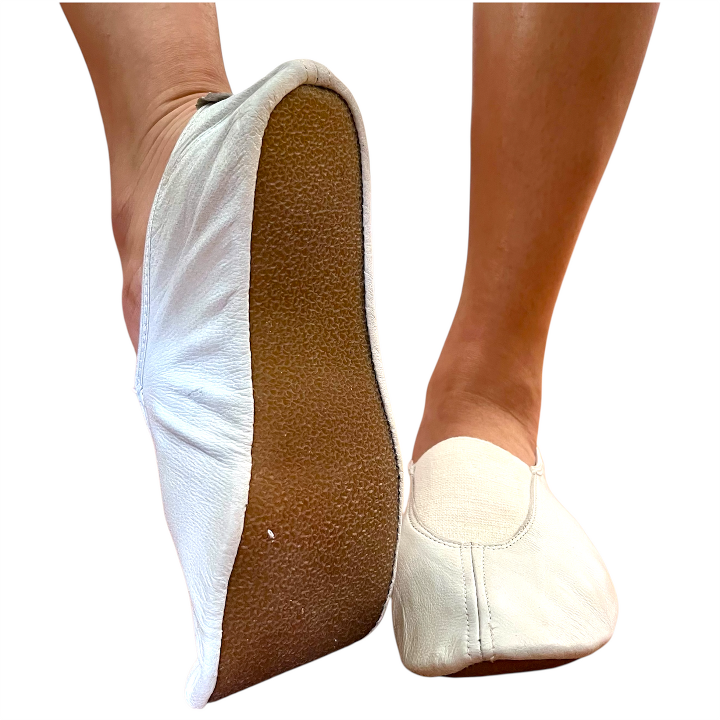 White ballet shoes with brown soles on a white background
