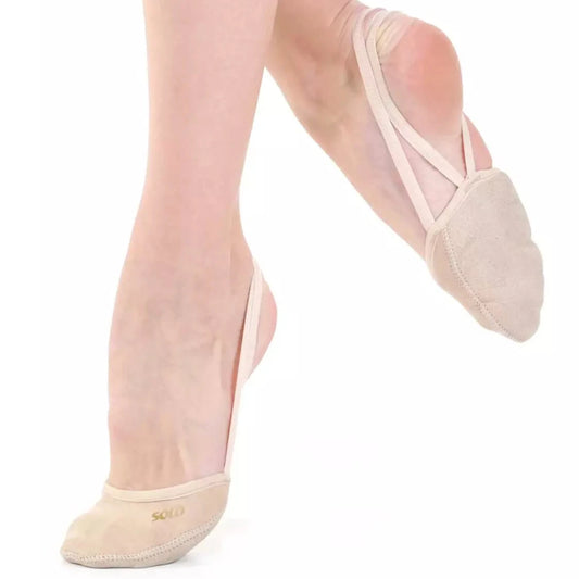 Ballet shoes worn with sheer pink tights on a white background