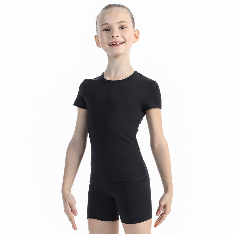 Young girl wearing a black leotard on a white background