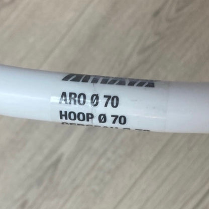 White cylindrical object with text on a wooden surface