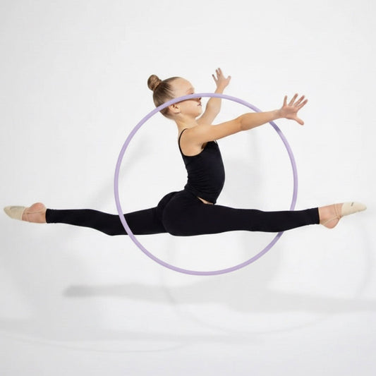 Gymnast performing a split leap with a hoop on a white background