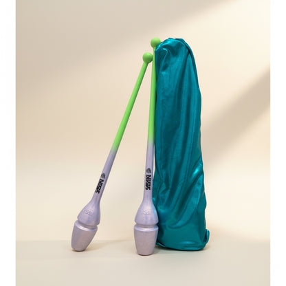 Pair of clubs with a green and gray gradient, wrapped in a teal cloth on a beige background.