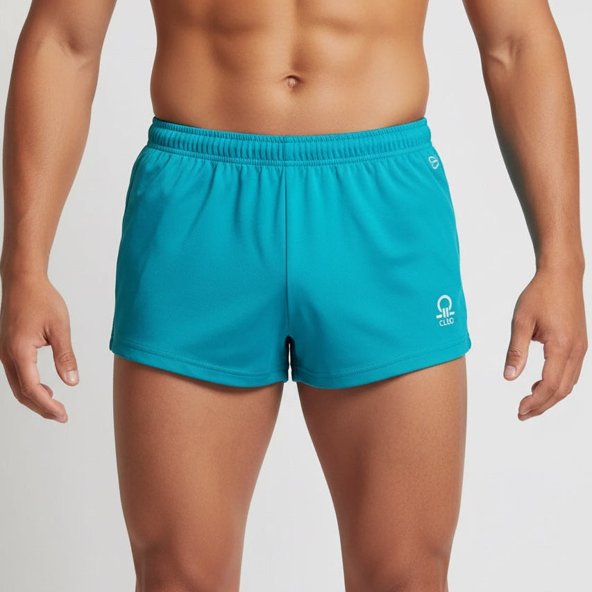 Person wearing teal shorts with a brand logo on a plain background