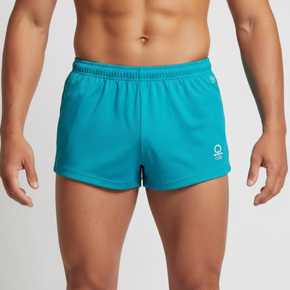 Person wearing teal shorts with a brand logo on a plain background