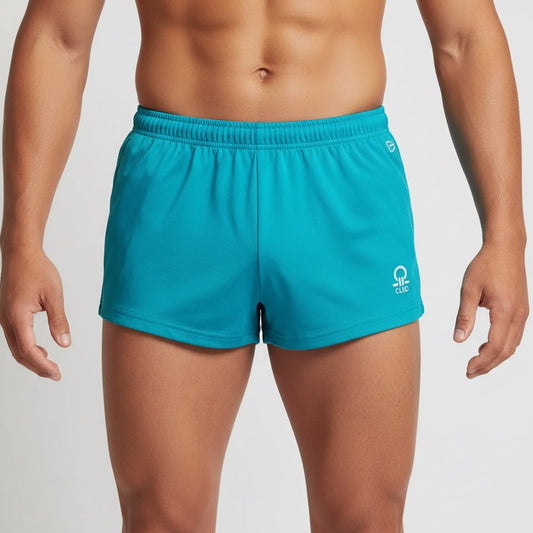 Person wearing teal shorts with a brand logo on a plain background