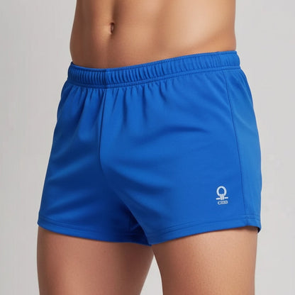 Blue athletic shorts with a logo on a neutral background