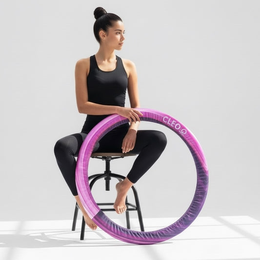 Woman holding a purple hula hoop with 'Cleo' branding on a white background