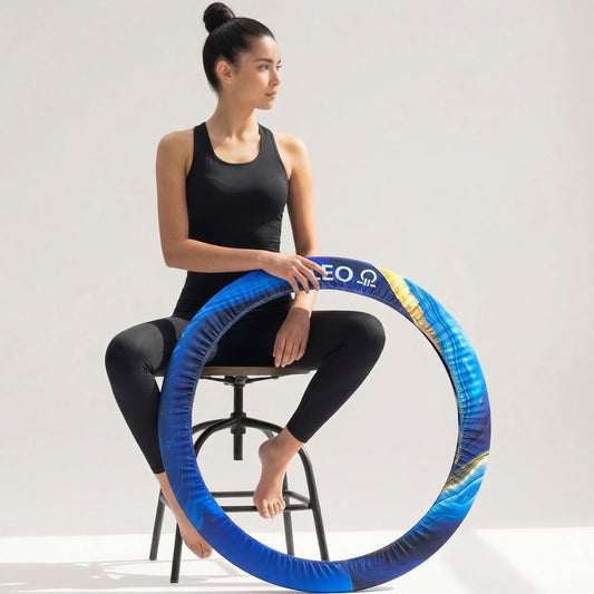 Woman holding a blue hula hoop on a gray background