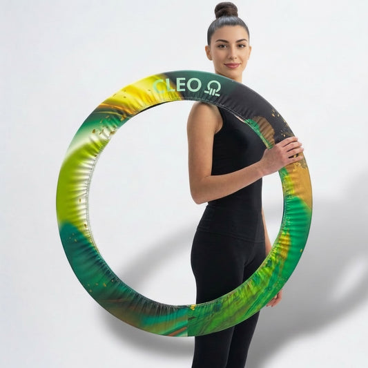 Woman holding a green and yellow exercise ring with 'CLEO' branding on a white background