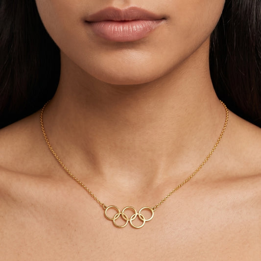 Gold necklace with interlocking rings worn by a model
