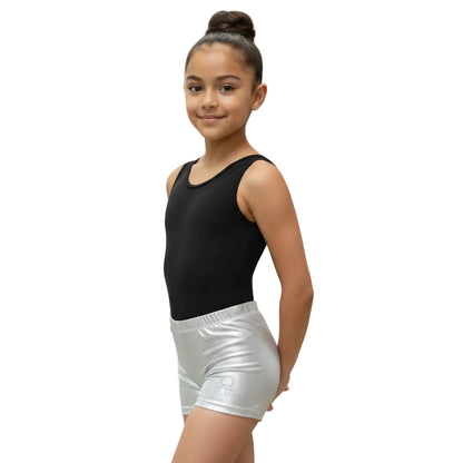 Young girl in a black tank top and silver shorts.