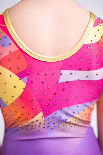Colorful leotard with geometric patterns and gold accents on a plain background