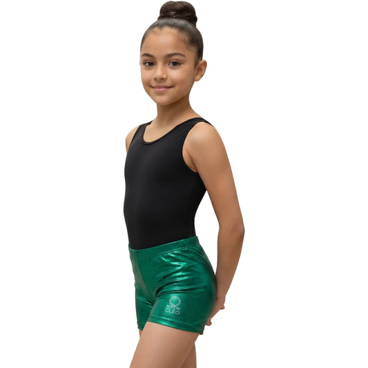 Young girl in black tank top and green shorts on a white background