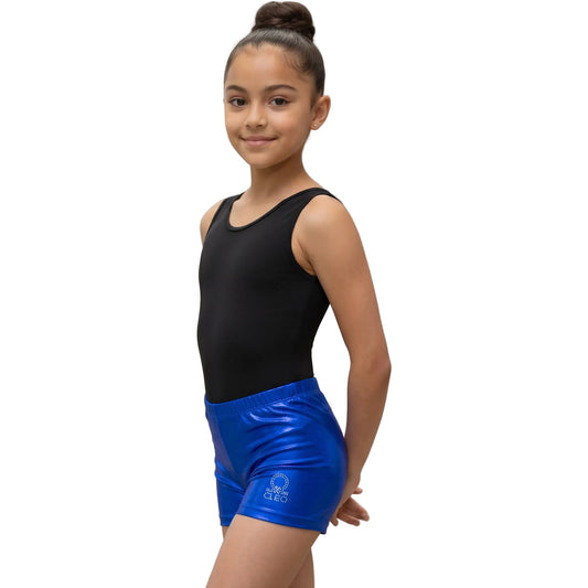 Young girl wearing a black tank top and blue shorts on a white background