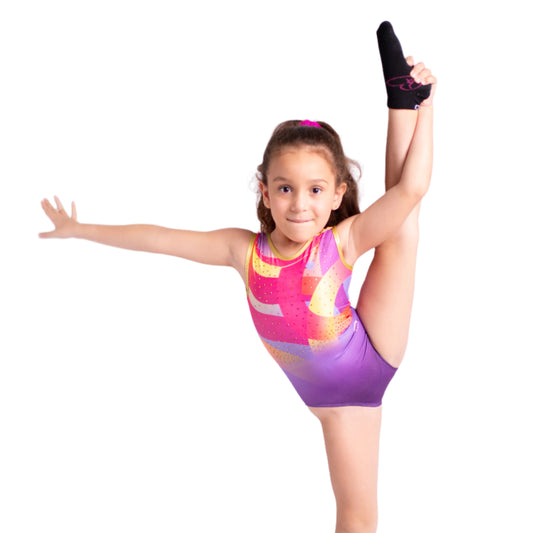 Young gymnast in a colorful leotard performing a split on a white background