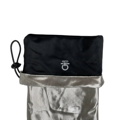 Black drawstring bag with silver top section on a light gray background