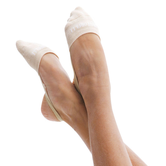 A pair of beige Pastorelli half socks worn on a person's feet, showing the socks fitting snugly and covering the toes.